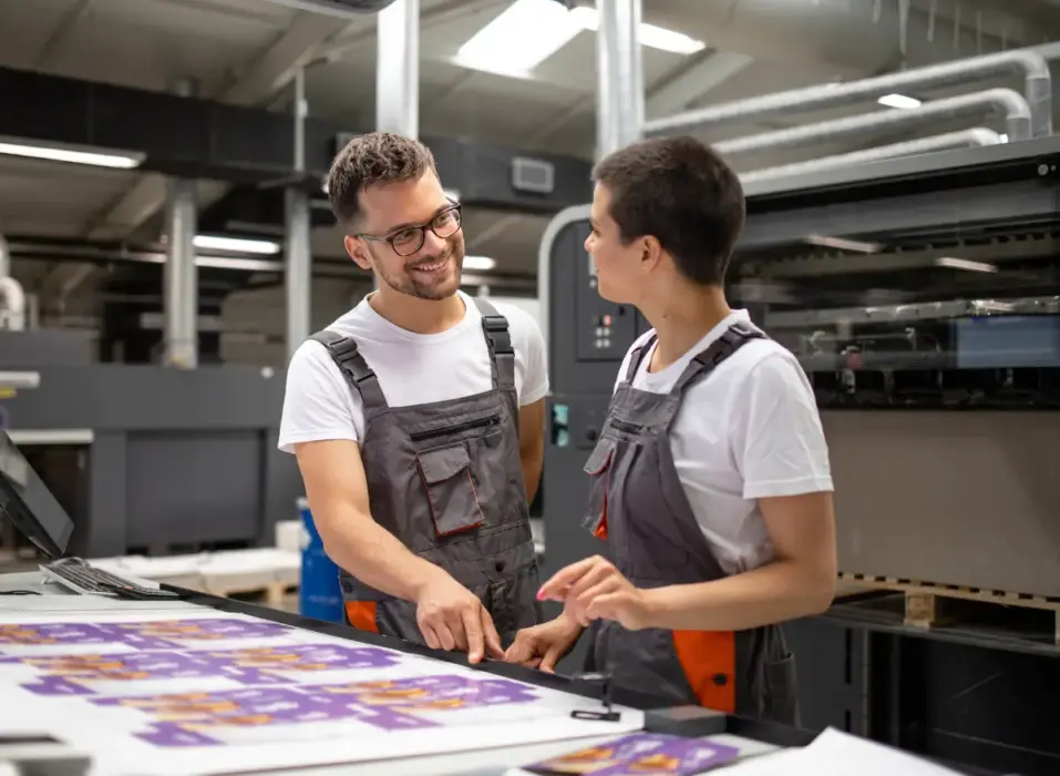 Printing professionals working with commercial printing equipment
